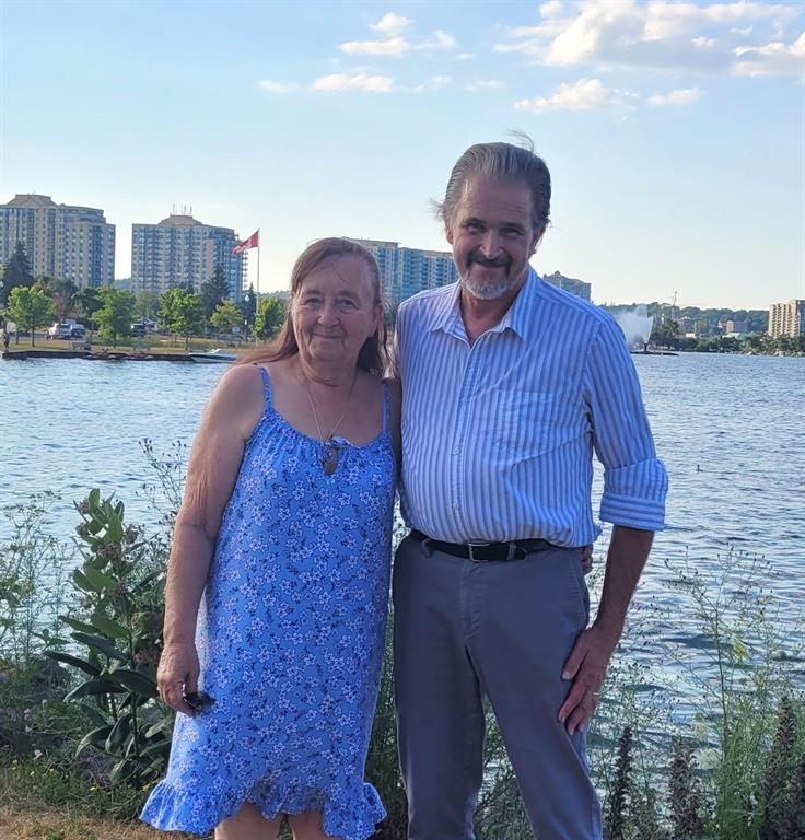 judy and brian reid by a lake